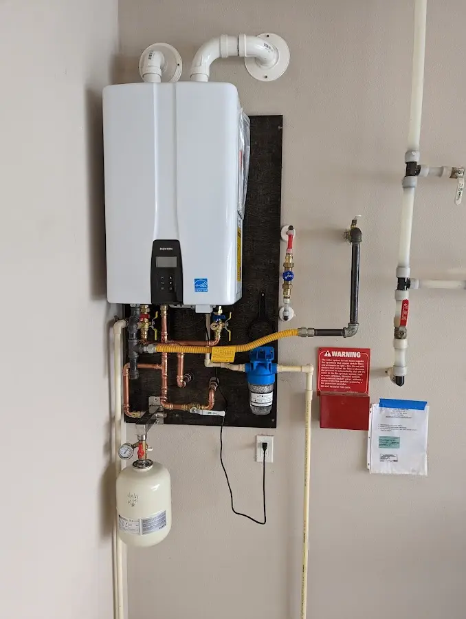 Professional plumber installing copper piping in a Vienna home